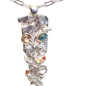 Sterling silver, gold-filled and copper pendant with black opal and red, orange, and yellow- colored sapphire gemstones.