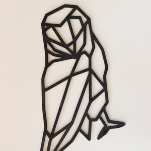 May include: Black geometric owl wall decor made of wood. The owl is in a standing position with its wings spread out.
