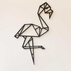 May include: Black geometric flamingo wall art. The flamingo is made of thin black lines that create a geometric design.