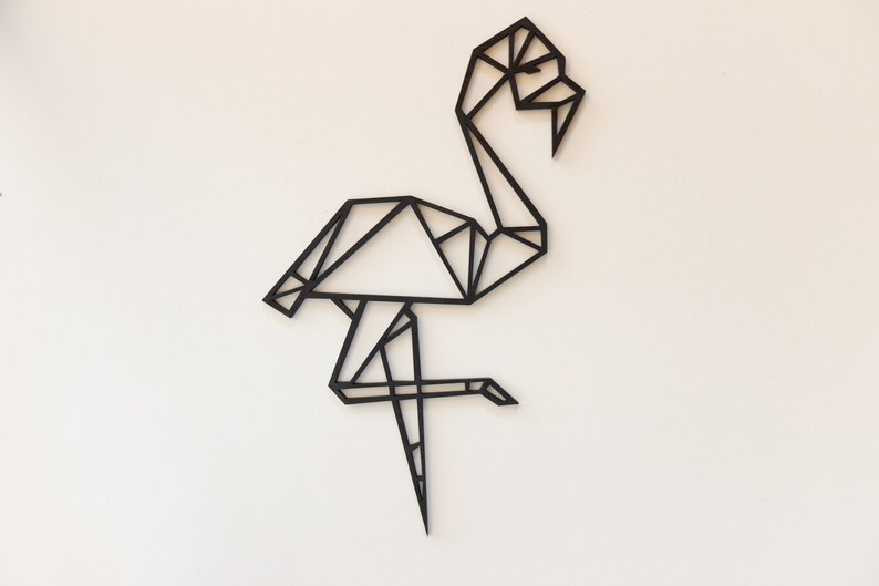 May include: Black geometric flamingo wall art. The flamingo is made of thin black lines that create a geometric design.