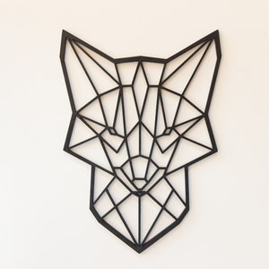 May include: Black geometric fox head wall decor made of wood. The fox head is a modern and minimalist design.