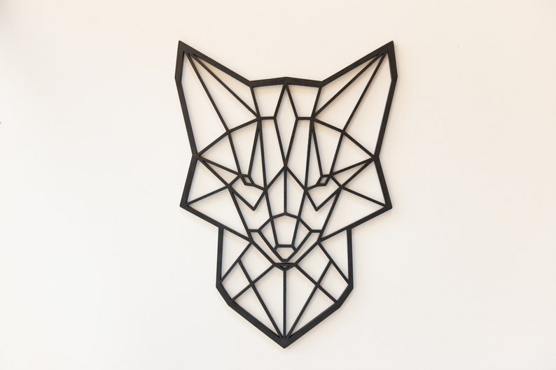 May include: Black geometric fox head wall decor made of wood. The fox head is a modern and minimalist design.