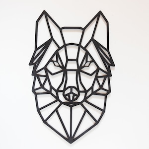 May include: Black geometric wolf head wall decor. The wolf is made of wood and has a geometric design. It is a great addition to any home decor.