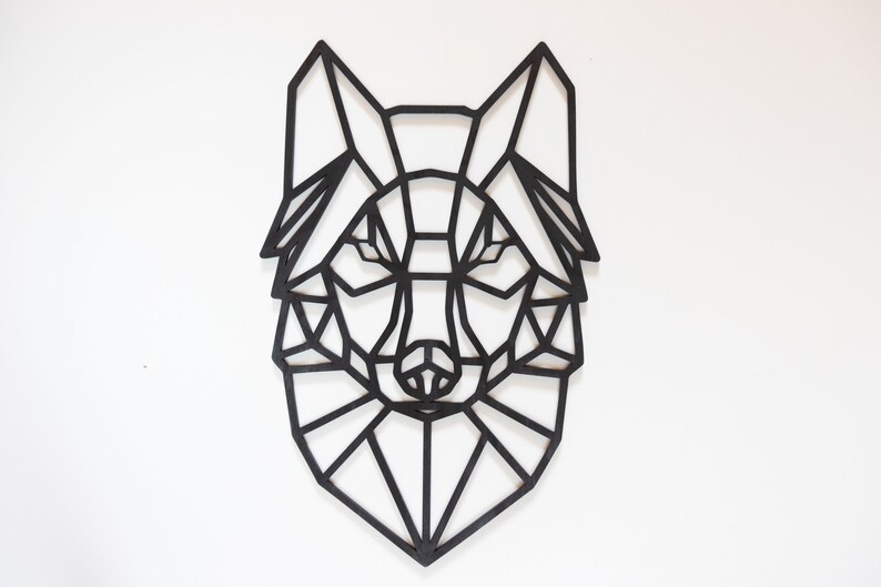 May include: Black geometric wolf head wall decor. The wolf is made of wood and has a geometric design. It is a great addition to any home decor.