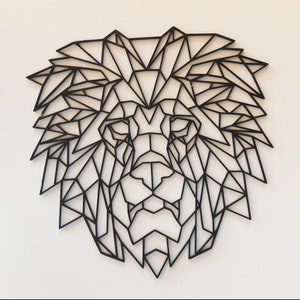 May include: Black geometric lion head wall decor. The lion's mane and face are made up of intricate black lines forming a geometric pattern.
