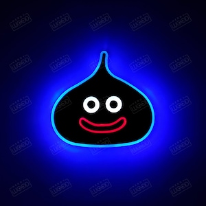 May include: A black and white neon sign of a smiling, cartoon-like blob with two large eyes. The sign is illuminated with a blue glow.