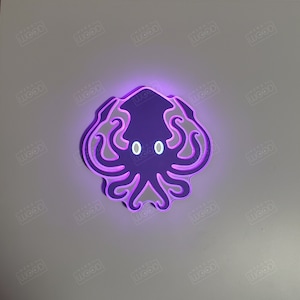 May include: A purple and white light-up wall decoration shaped like an octopus with glowing eyes.