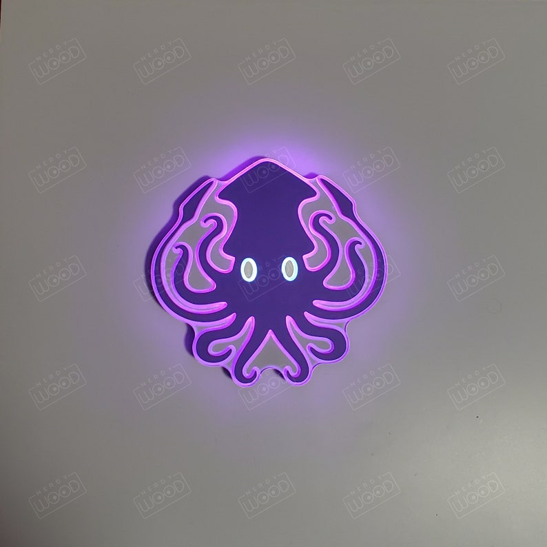 May include: A purple and white light-up wall decoration shaped like an octopus with glowing eyes.
