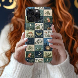 May include: A smartphone case featuring a grid pattern of square tiles. Each tile displays nature-themed illustrations including foxes, frogs, snails, moths, birds, mushrooms, ferns, starry night skies, crescent moons, and a sun with a face.