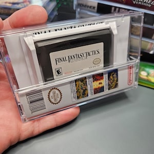 May include: A clear plastic case with a black Game Boy Advance game cartridge inside. The game is Final Fantasy Tactics Advance, with the ESRB rating "E" for Everyone. The case has a barcode and the text "Official Nintendo Seal" on the side.