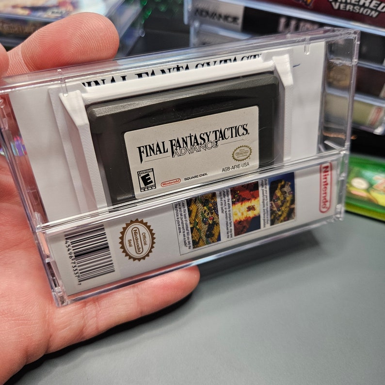 May include: A clear plastic case with a black Game Boy Advance game cartridge inside. The game is Final Fantasy Tactics Advance, with the ESRB rating "E" for Everyone. The case has a barcode and the text "Official Nintendo Seal" on the side.