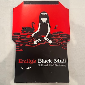 May include: Black and red envelope with a black and white illustration of a girl sitting with two cats. The text "Emily's Black Mail Fold and Mail Stationery" is printed on the envelope.