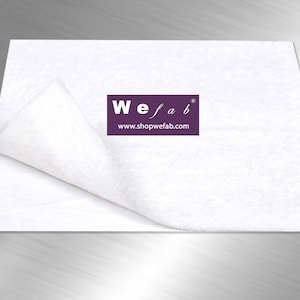 May include: White, non-woven fabric sheet with a folded edge. The sheet has a purple logo that reads "We fab" and "www.shopwefab.com".