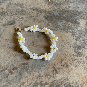 Yellow, white, and shiny purple white beaded flower bracelet