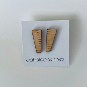 May include: A pair of wooden earrings shaped like a ruler with a brown wood finish. The earrings are displayed on a white card with the text "adhloops.com".