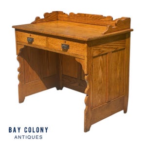 Antique Victorian Tiger Oak Raised Panel Two Drawer Desk with Scrolled Gallery