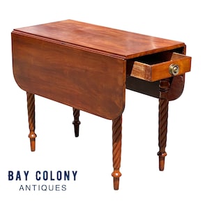 May include: A mahogany drop leaf table with a single drawer and turned legs. The table is in good condition and has a rich patina.