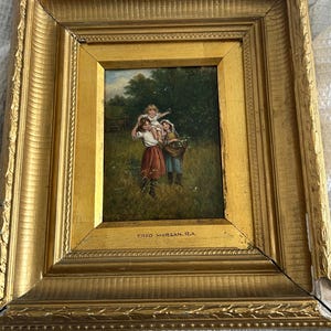 May include: A framed oil painting of three children in a field. The children are wearing colorful clothing and are holding a basket of flowers. The painting is signed "Fred Morgan, R.A."