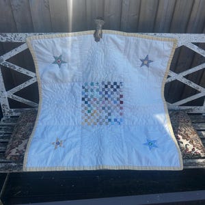 May include: A white ceramic mug with a black handle and the text "But First, Coffee" in a handwritten style. The mug is on a white surface. The mug is likely for hot beverages.