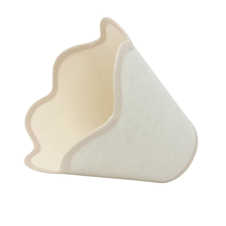 May include: A white fabric lampshade with a scalloped edge and a beige trim. The lampshade is made of a textured fabric and has a conical shape.