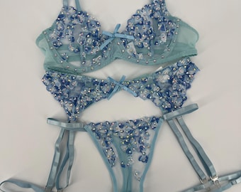 Completo intimo in pizzo azzurro, reggiseno decorato con strass, reggicalze, slip