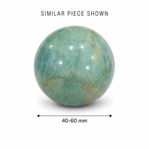 May include: A polished, spherical gemstone in shades of teal and green, with natural veining and cracks. The text "SIMILAR PIECE SHOWN" is at the top. The sphere measures 40-60 mm in diameter.