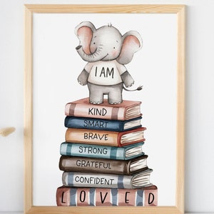 May include: A watercolour illustration of a grey elephant wearing a white shirt with the words "I AM" printed on it. The elephant is standing on a stack of colourful books with words like "KIND", "SMART", "BRAVE", "STRONG", "GRATEFUL", "CONFIDENT", and "LOVED" printed on them.