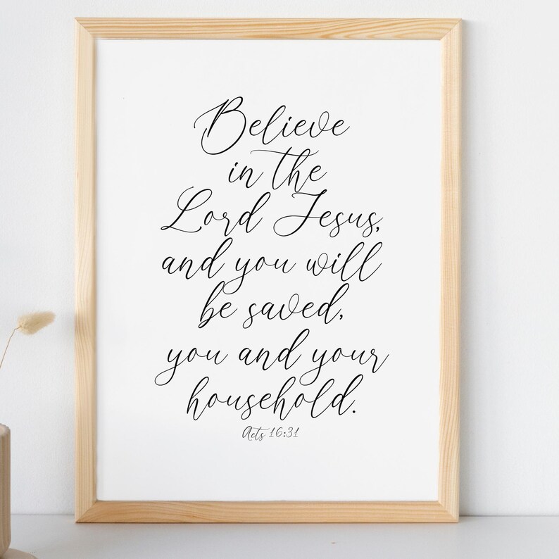 May include: A framed print with a white background and black text. The text reads "Believe in the Lord Jesus, and you will be saved. You and your household. Acts 16:31".