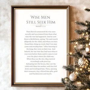 May include: A framed print with the text "WISE MEN STILL SEEK HIM" and a passage from Matthew 2: 7-11. The print is in a gold frame and is decorated with a Christmas tree with ornaments.