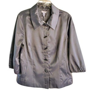 May include: A gray satin button-up jacket with a collar and long sleeves. The jacket has a fitted silhouette and features black buttons.