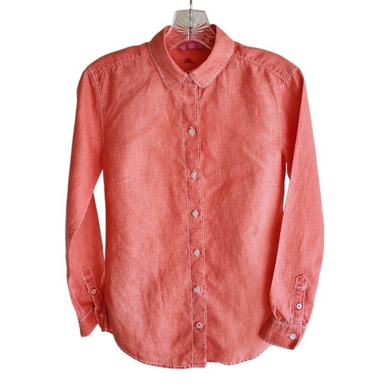 May include: A long-sleeved, coral linen button-down shirt with a classic collar and a button-up front.