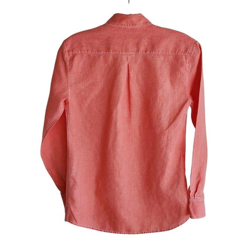 May include: A coral coloured long-sleeved button-down shirt with a classic collar and a single back pleat.