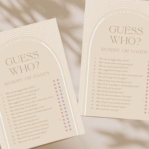 May include: Two printable baby shower game cards with a beige background and brown text. The cards feature an archway design with the text "Guess Who? Mommy or Daddy" and a list of questions about the parents-to-be.  The questions are followed by a column of pink and blue hearts for guests to mark their guesses.