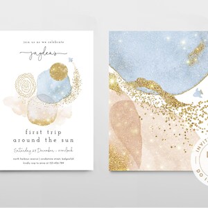 May include: A printable invitation template for a baby's first birthday party. The front of the invitation features a watercolor design with blue and pink abstract shapes and gold glitter. The text on the front reads "Join us as we celebrate Jayden's first trip around the sun. Saturday 23 December - Ireland. North Harbour Reserve | Condamine Street, Balgowlah. Kindly RSVP to Anna or 02 933 456 789". The back of the invitation features a similar watercolor design with gold glitter.