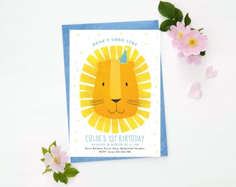May include: A blue and white birthday invitation with a yellow lion face wearing a blue party hat. The text on the invitation reads "Roar 'n Good Time" and "Chloe's 1st Birthday".