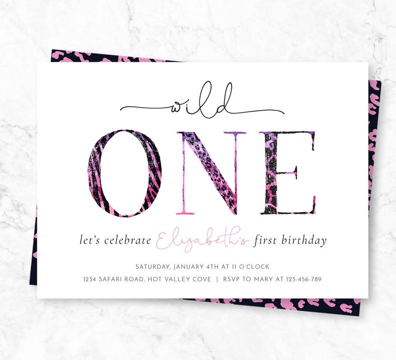 May include: A white invitation card with the words "wild ONE" in large, stylized letters. The "O" has a zebra print, and the "NE" has a leopard print. The text "let's celebrate Elizabeth's first birthday" is also included.
