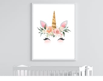 May include: A white unicorn head with a gold glitter horn and pink and peach flowers. The unicorn has closed eyes and long eyelashes.
