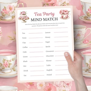 May include: A pink and white tea party game card with the text "Tea Party MIND MATCH". The card features illustrations of teacups and a cake. The game has fill-in-the-blank phrases.