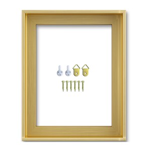 May include: A gold-coloured picture frame with a white interior. Includes hanging hardware: white hooks, gold-coloured D-rings, and gold-coloured screws. The frame has a simple, elegant design.