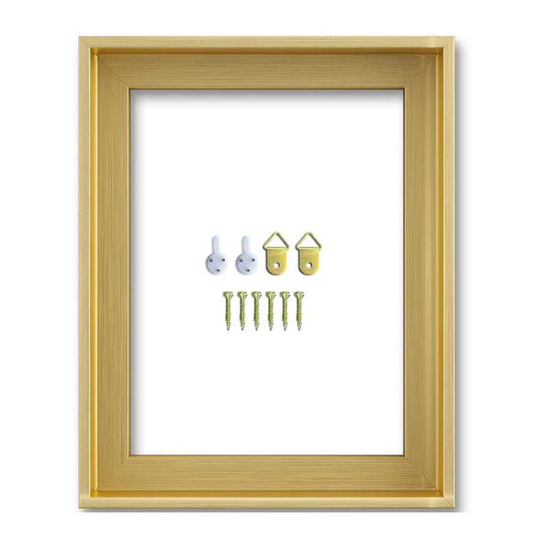 May include: A gold-coloured picture frame with a white interior. Includes hanging hardware: white hooks, gold-coloured D-rings, and gold-coloured screws. The frame has a simple, elegant design.
