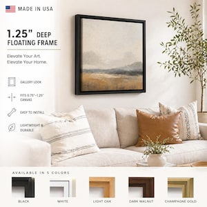 May include: A framed canvas art piece with a black 1.25-inch deep floating frame. The artwork depicts a landscape with muted tones of beige, gray, and brown. The frame is easy to install and available in five colors.