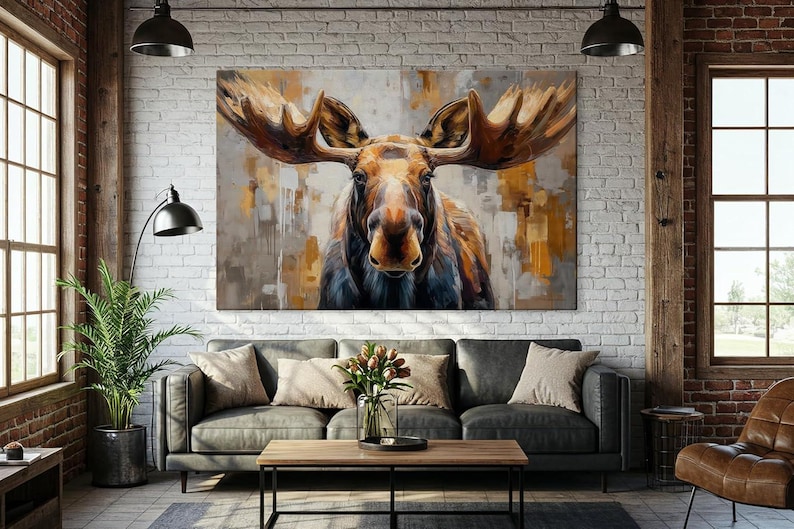 Pu&ograve; includere: Una grande stampa artistica su tela di un alce con grandi corna. L'alce &egrave; dipinto in tonalit&agrave; di marrone, oro e grigio, con un focus sul volto e sulle corna dell'animale. L'opera d'arte &egrave; esposta sopra un divano grigio.
