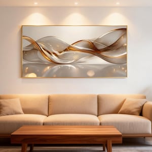 May include: Abstract wall art featuring flowing, translucent ribbons in shades of gold and brown, set against a neutral background. The artwork is framed in a gold-colored border, creating a modern and elegant aesthetic.
