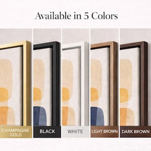 May include: Abstract art prints in five frame colors: champagne gold, black, white, light brown, and dark brown. Each framed print features a beige background with orange and blue geometric shapes. The text "Available in 5 Colors" is at the top.