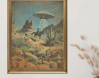 May include: A framed vintage print showing a cowboy riding a horse in a desert scene, with a UFO overhead. The artwork includes cacti, mountains, and a retro colour scheme, presented within a gold frame.