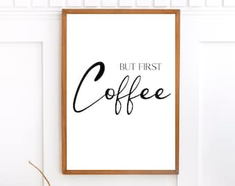 Puede incluir: Una impresión enmarcada con fondo blanco y texto negro que dice "But first, coffee".