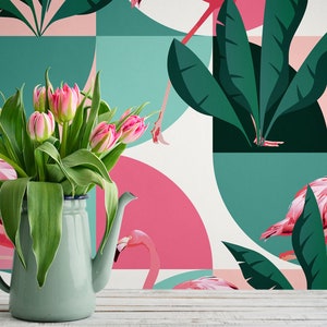 May include: A green ceramic pitcher filled with pink tulips sits in front of a wallpaper with a geometric pattern of pink and green circles and leaves. The wallpaper features pink flamingos.
