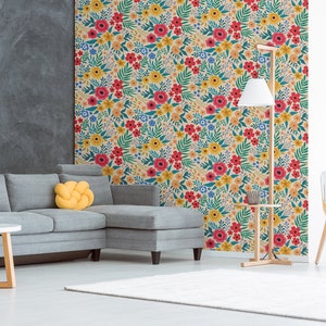 May include: A living room interior design with a gray sectional sofa, a yellow throw pillow, a wooden coffee table, a floor lamp with a white shade, a wooden side table, and a yellow chair. The wall behind the sofa is covered with a floral wallpaper featuring red, yellow, and blue flowers on a cream background.
