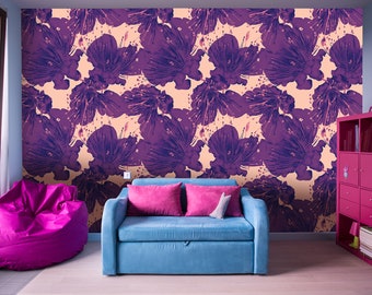 May include: A living room interior with a blue sofa, a pink beanbag chair, and a pink bookshelf. The wall is covered in a floral wallpaper with a purple and pink floral pattern.