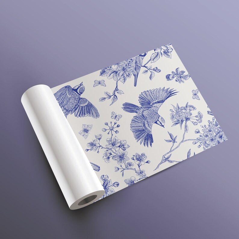 May include: A white background with a blue and white floral pattern featuring birds. The pattern is repeated throughout the design. The background is a white roll of paper.